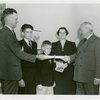Typical American Family - Filkins family receiving lease and key from Harvey Gibson