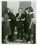 Typical American Family - Flanagan family receiving lease and key from Harvey Gibson