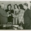 Typical American Family - Flanagan family children receiving charm bracelets from Harvey Gibson