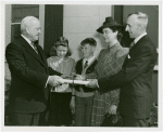 Typical American Family - Ebert family receiving key and lease from Harvey Gibson