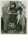 Typical American Family - Gran family receiving key and lease from Harvey Gibson