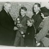 Typical American Family - Hearn family children receiving signed baseball and charm bracelet from Harvey Gibson
