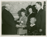 Typical American Family - Hansen family children receiving signed baseball and charm bracelet from Harvey Gibson