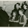 Typical American Family - Karges family children receiving signed baseball and charm bracelet from Harvey Gibson