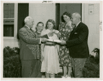 Typical American Family - Mullen family receiving keys and lease from Harvey Gibson