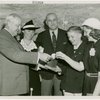 Typical American Family - Mullen family children receiving signed baseball and charm bracelet from Harvey Gibson