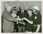 Typical American Family - Mullen family children receiving signed baseball and charm bracelet from Harvey Gibson