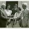 Typical American Family - Madison family receiving keys and lease from Harvey Gibson