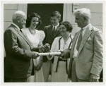 Typical American Family - Madison family receiving keys and lease from Harvey Gibson