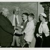 Typical American Family - Madison family children receiving signed baseball and charm bracelet from Harvey Gibson