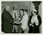 Typical American Family - Madison family children receiving signed baseball and charm bracelet from Harvey Gibson