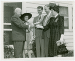 Typical American Family - Morris family receiving key and lease from Harvey Gibson