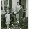 Typical American Family - MacKenzie family receiving key and lease from Harvey Gibson
