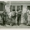 Typical American Family - MacKenzie family in front of house with cow