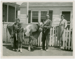 Typical American Family - MacKenzie family in front of house with cow