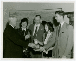 Typical American Family - Morris family children receiving signed baseball and charm bracelet from Harvey Gibson