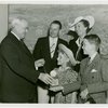 Typical American Family - MacKenzie family children receiving signed baseball and charm bracelet from Harvey Gibson