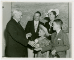 Typical American Family - MacKenzie family children receiving signed baseball and charm bracelet from Harvey Gibson
