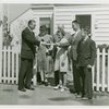 Typical American Family - Petersen family receiving lease and key from man
