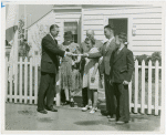 Typical American Family - Petersen family receiving lease and key from man