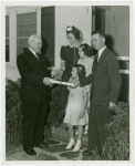 Typical American Family - Ogle family receiving key and lease from Harvey Gibson