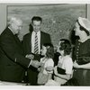 Typical American Family - Ogle family children receiving charm bracelets from Harvey Gibson