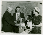 Typical American Family - Ogle family children receiving charm bracelets from Harvey Gibson