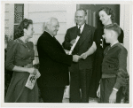 Typical American Family - Pumel family receiving key and lease from Harvey Gibson