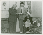 Typical American Family - Roberts family receiving key and lease from Harvey Gibson