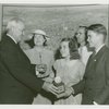 Typical American Family - Rorer family children receiving signed baseball and charm bracelet from Harvey Gibson