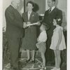 Typical American Family - Schaeffer family receiving key and lease from Harvey Gibson