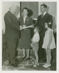 Typical American Family - Schaeffer family receiving key and lease from Harvey Gibson