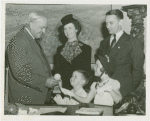 Typical American Family - Schaeffer family children receiving signed baseball and charm bracelet from Harvey Gibson