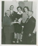 Typical American Family - Westbrook family receiving key and lease from Harvey Gibson