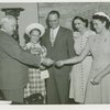 Typical American Family - Ward family children receiving bracelets from Harvey Gibson