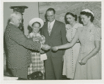 Typical American Family - Ward family children receiving bracelets from Harvey Gibson