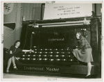 Underwood Elliott Fisher Co. - Two women posing with giant typewriter
