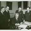 Vermont Participation - George Aiken (Governor) signing bill as officials look on