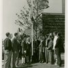 Washington (State) Participation - Group raising Washington flag outside building