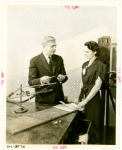 Westinghouse - Man and woman examining vapor lamp