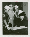 Women's Groups - Anna Neagle signing guestbook while Anna Kross, Bertha McCann and Dorothy Frooks looks on