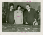 Yugoslavia Participation - Constantin Fotich (Ambassador) looking at Fair model with man and woman