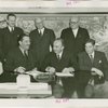 Yugoslavia Participation - Grover Whalen and Constantin Fotich (Ambassador) signing contract while officials watch