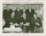 Yugoslavia Participation - Grover Whalen and Constantin Fotich (Ambassador) signing contract while officials watch