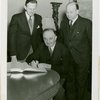 Yugoslavia Participation - Constantin Fotich (Ambassador) signing guestbook while Julius Holmes and Edward Roosevelt look on