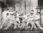 Rosalind Russell and chorus boys dressed as Brazilian cadets in Wonderful Town