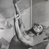 Donald McKayle 3/4 portrait with arms raised.