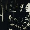 Jack Kerouac sitting in plaid shirt