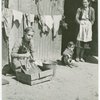 They wash rags. Argeles women's camp. Woman working outside barrack