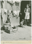 They wash rags. Argeles women's camp. Woman working outside barrack